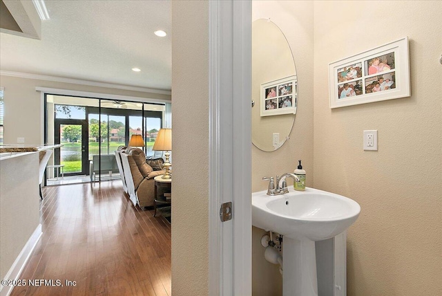 13409 Isla Vista Dr, Jacksonville, FL 32224 - bathroom with ornamental molding, wood finished floors, recessed lighting, a textured wall, and baseboards