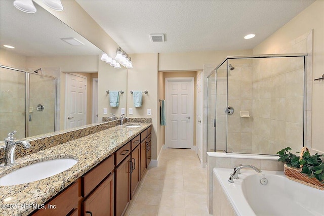 13409 Isla Vista Dr, Jacksonville, FL 32224 - bathroom with a stall shower, double vanity, a bath, tile patterned floors, and a textured ceiling
