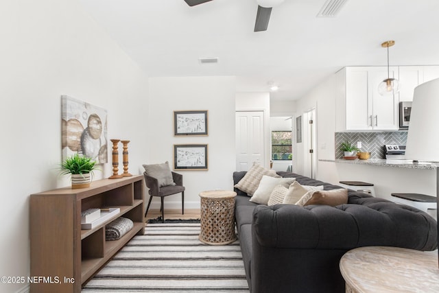 3832 Bunnell Dr, Jacksonville, FL 32246 - living room with ceiling fan and baseboards