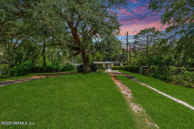 86290 Weldon Ave, Yulee, FL 32097 - yard at dusk featuring driveway, a yard, and an attached carport