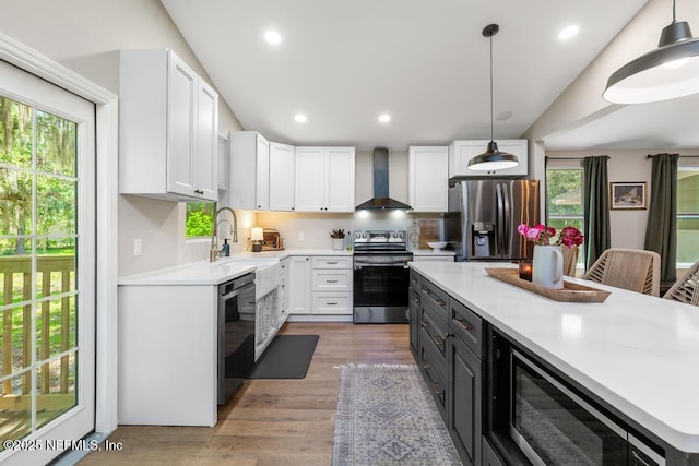 86290 Weldon Ave, Yulee, FL 32097 - kitchen featuring appliances with stainless steel finishes, wall chimney exhaust hood, plenty of natural light, white cabinets, and recessed lighting