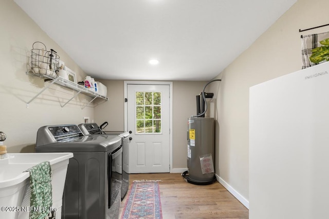 86290 Weldon Ave, Yulee, FL 32097 - washroom featuring separate washer and dryer, electric water heater, light wood-style flooring, recessed lighting, and baseboards