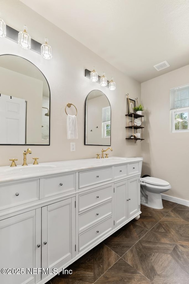 86290 Weldon Ave, Yulee, FL 32097 - bathroom with double vanity, toilet, and baseboards