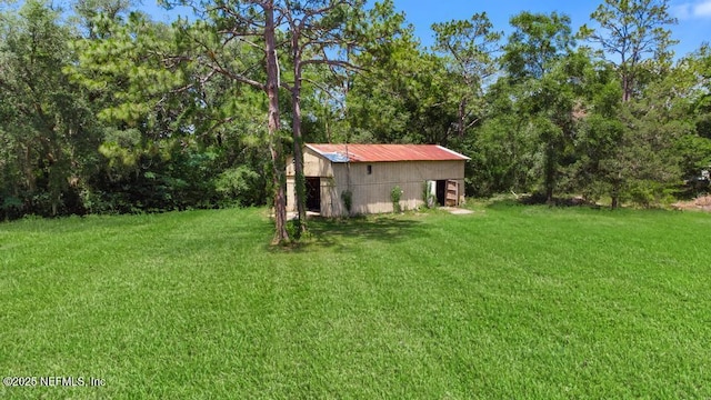 86290 Weldon Ave, Yulee, FL 32097 - view of green lawn with a pole building, an outdoor structure, and a wooded view