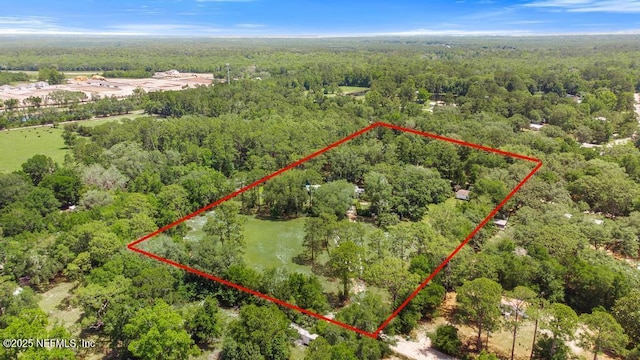 86290 Weldon Ave, Yulee, FL 32097 - aerial view of property and surrounding area with a heavily wooded area and property parcel outlined