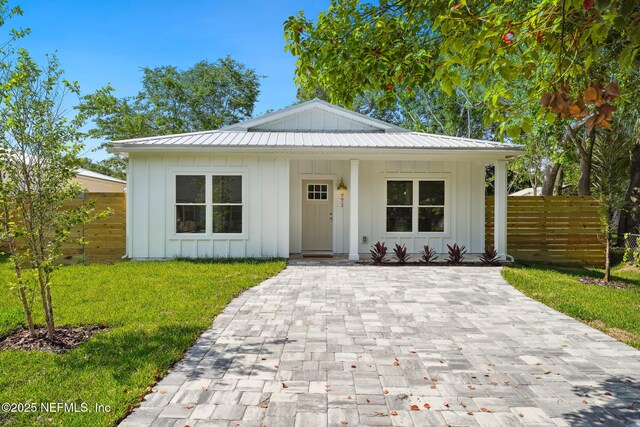 771 W 4th St, Saint Augustine, FL 32084 - bungalow-style house featuring board and batten siding, covered porch, and metal roof