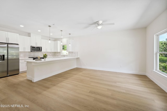 771 W 4th St, Saint Augustine, FL 32084 - kitchen featuring stainless steel appliances, light countertops, healthy amount of natural light, a peninsula, and recessed lighting