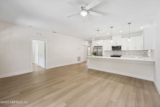771 W 4th St, Saint Augustine, FL 32084 - unfurnished living room featuring recessed lighting, baseboards, ceiling fan, and light wood-type flooring