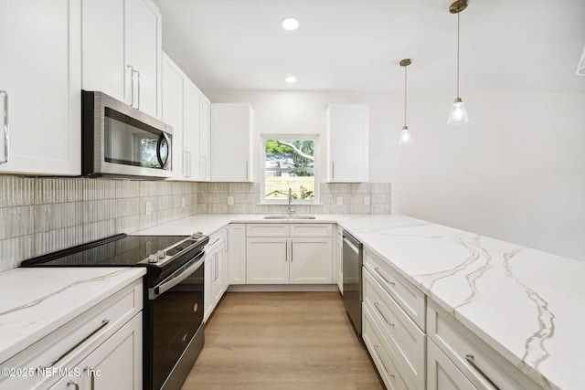 771 W 4th St, Saint Augustine, FL 32084 - kitchen featuring appliances with stainless steel finishes, a sink, tasteful backsplash, white cabinetry, and recessed lighting