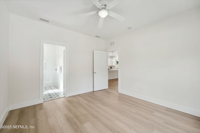771 W 4th St, Saint Augustine, FL 32084 - unfurnished bedroom featuring light wood finished floors, baseboards, ensuite bath, and a ceiling fan