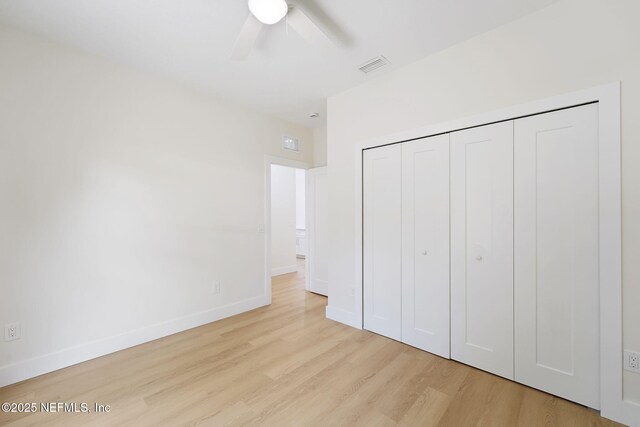 771 W 4th St, Saint Augustine, FL 32084 - unfurnished bedroom featuring wood finished floors, baseboards, a closet, and ceiling fan