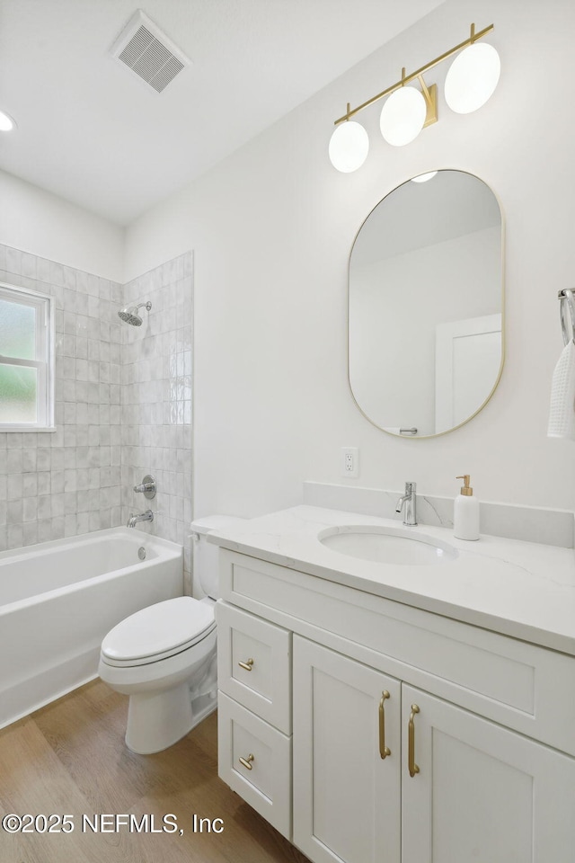 771 W 4th St, Saint Augustine, FL 32084 - full bathroom featuring vanity, toilet, wood finished floors, and bathing tub / shower combination