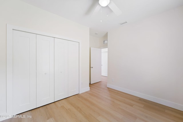 771 W 4th St, Saint Augustine, FL 32084 - unfurnished bedroom featuring light wood-style flooring, a closet, baseboards, and ceiling fan