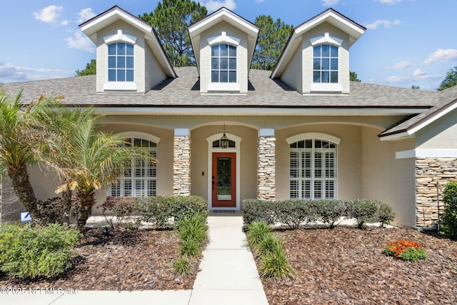 86569 N Hampton Club Way, Fernandina Beach, FL 32034 - view of front of home featuring stone siding, roof with shingles, and stucco siding