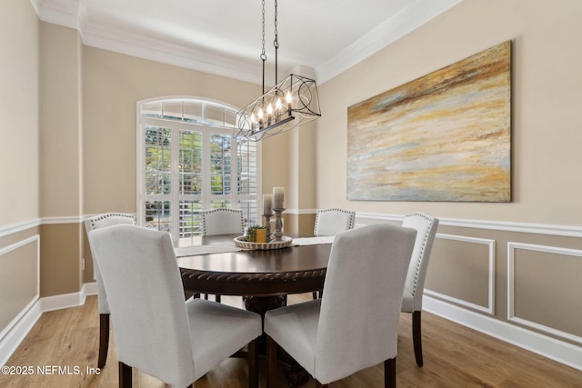 86569 N Hampton Club Way, Fernandina Beach, FL 32034 - dining space featuring crown molding, a chandelier, and wood finished floors