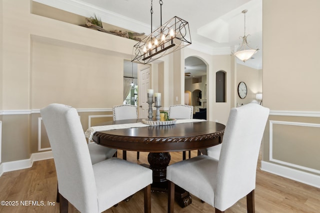 86569 N Hampton Club Way, Fernandina Beach, FL 32034 - dining room with ornamental molding, wood finished floors, arched walkways, and a chandelier