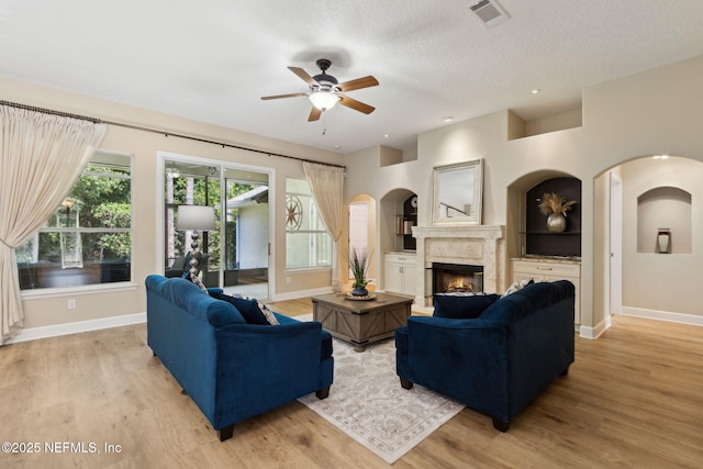 86569 N Hampton Club Way, Fernandina Beach, FL 32034 - living room featuring ceiling fan, baseboards, light wood finished floors, a high end fireplace, and built in features