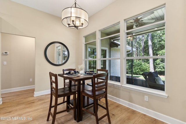 86569 N Hampton Club Way, Fernandina Beach, FL 32034 - dining room featuring baseboards, a chandelier, and light wood-style floors