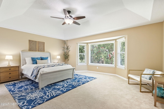 86569 N Hampton Club Way, Fernandina Beach, FL 32034 - carpeted bedroom with a tray ceiling, baseboards, and a ceiling fan