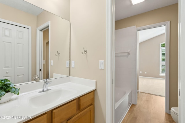 86569 N Hampton Club Way, Fernandina Beach, FL 32034 - bathroom with wood finished floors, toilet, vanity, and bathtub / shower combination