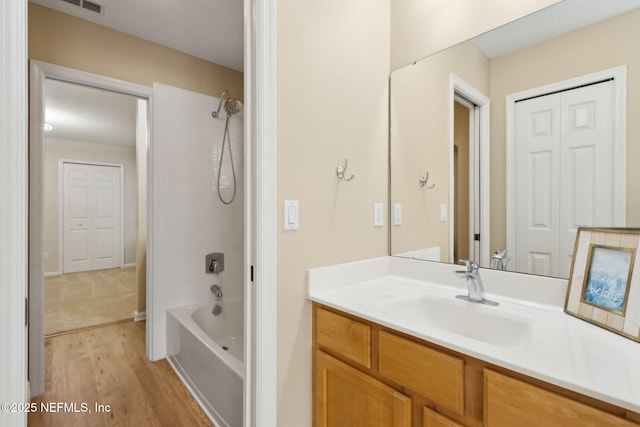 86569 N Hampton Club Way, Fernandina Beach, FL 32034 - bathroom with vanity, washtub / shower combination, wood finished floors, and toilet