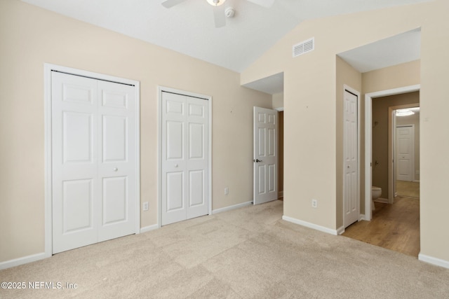 86569 N Hampton Club Way, Fernandina Beach, FL 32034 - unfurnished bedroom with multiple closets, carpet floors, lofted ceiling, baseboards, and ceiling fan