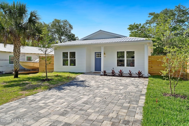763 W 4th St, Saint Augustine, FL 32084 - view of front of home with metal roof and a standing seam roof