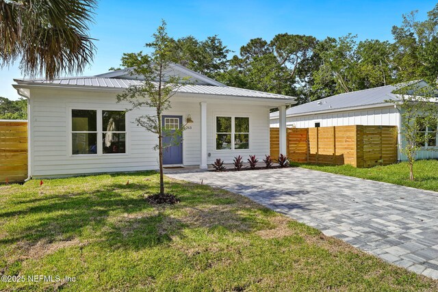 763 W 4th St, Saint Augustine, FL 32084 - view of front of home with a porch and metal roof