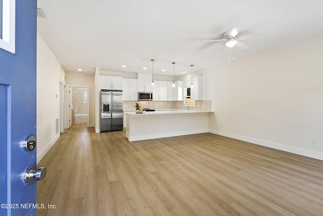 763 W 4th St, Saint Augustine, FL 32084 - unfurnished living room with a ceiling fan, light wood finished floors, baseboards, and recessed lighting
