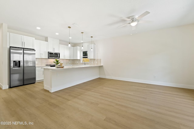763 W 4th St, Saint Augustine, FL 32084 - kitchen with stainless steel appliances, light countertops, decorative backsplash, recessed lighting, and a peninsula
