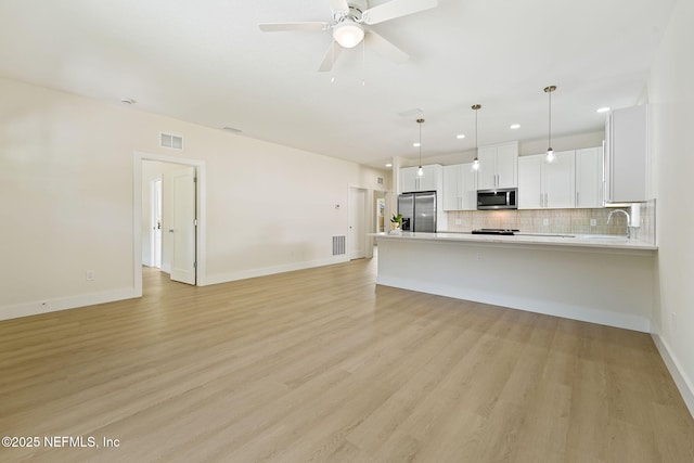 763 W 4th St, Saint Augustine, FL 32084 - unfurnished living room with recessed lighting, ceiling fan, baseboards, and light wood finished floors
