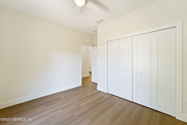 763 W 4th St, Saint Augustine, FL 32084 - unfurnished bedroom featuring light wood-style floors, a closet, baseboards, and a ceiling fan
