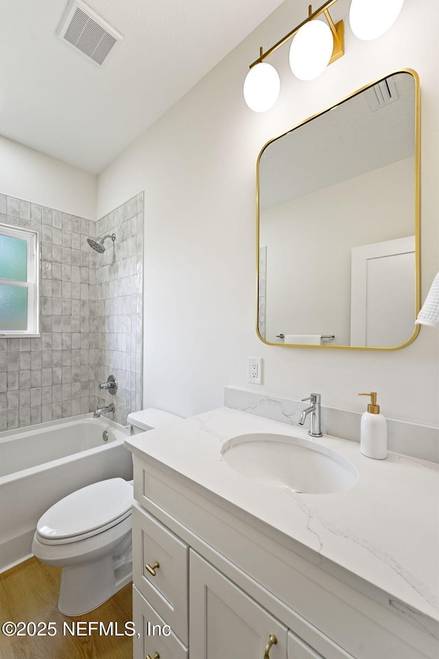 763 W 4th St, Saint Augustine, FL 32084 - bathroom featuring vanity, toilet, shower / washtub combination, and wood finished floors