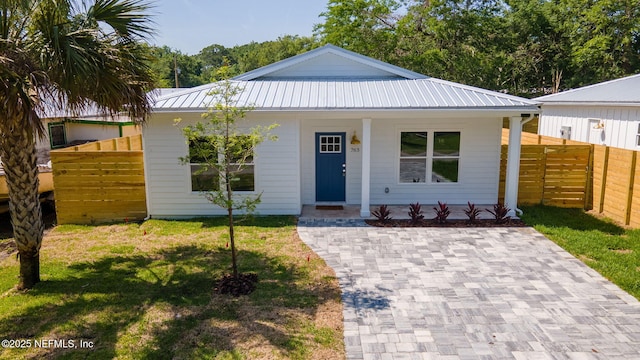 763 W 4th St, Saint Augustine, FL 32084 - view of front of house with a porch and metal roof
