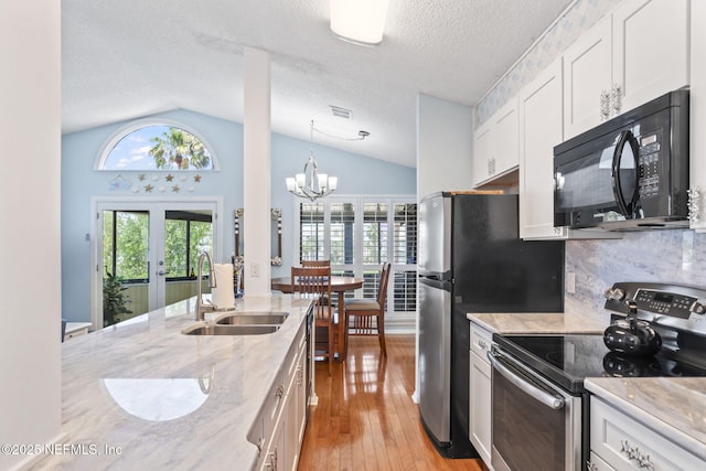 118 Governor St Unit 208, Green Cove Springs, FL 32043 - kitchen with black microwave, electric stove, a sink, lofted ceiling, and french doors