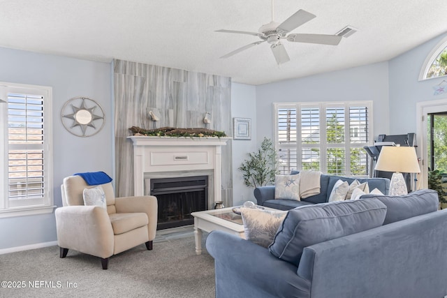 118 Governor St Unit 208, Green Cove Springs, FL 32043 - carpeted living room with a large fireplace, ceiling fan, baseboards, a textured ceiling, and vaulted ceiling