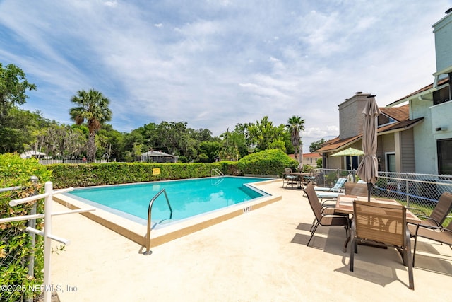 118 Governor St Unit 208, Green Cove Springs, FL 32043 - community pool featuring a patio, outdoor dining area, and view of scattered trees