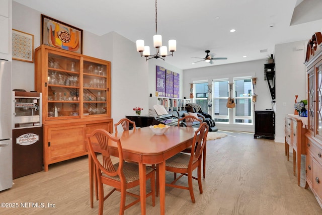 1622 Bridgeton Dr, Jacksonville, FL 32207 - dining space featuring light wood-style flooring, a ceiling fan, a chandelier, and recessed lighting