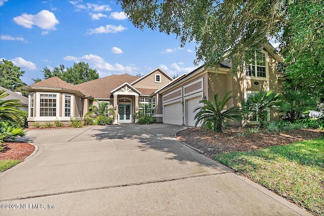 2347 W Clovelly Ln, Saint Augustine, FL 32092 - view of front of home featuring concrete driveway, stucco siding, a garage, and french doors