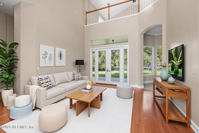 2347 W Clovelly Ln, Saint Augustine, FL 32092 - living area with a high ceiling, arched walkways, wood finished floors, french doors, and baseboards