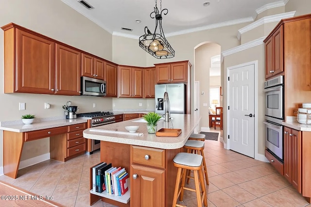 2347 W Clovelly Ln, Saint Augustine, FL 32092 - kitchen featuring stainless steel appliances, light tile patterned floors, light countertops, a sink, and a breakfast bar area