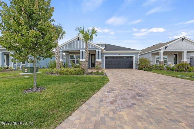 50 Dollar Ct, Saint Augustine, FL 32092 - craftsman house featuring a garage, a front lawn, decorative driveway, and stone siding