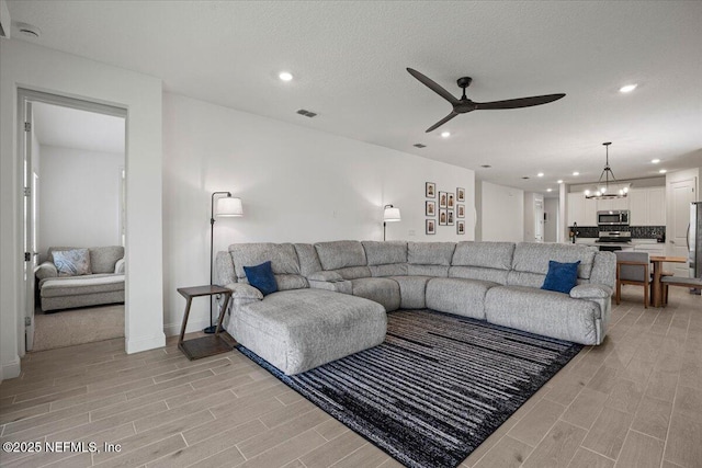 50 Dollar Ct, Saint Augustine, FL 32092 - living area with ceiling fan, wood finish floors, recessed lighting, a chandelier, and baseboards