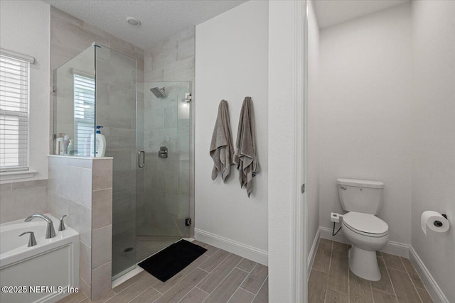 50 Dollar Ct, Saint Augustine, FL 32092 - bathroom with a garden tub, a shower stall, toilet, wood finish floors, and baseboards