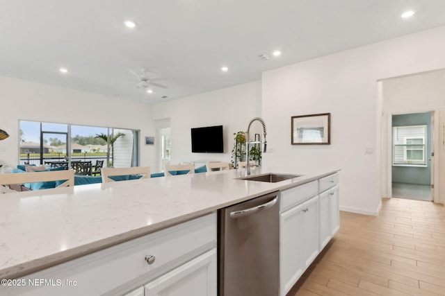 85541 Stonehurst Pkwy, Fernandina Beach, FL 32034 - kitchen featuring dishwasher, open floor plan, a sink, ceiling fan, and white cabinetry