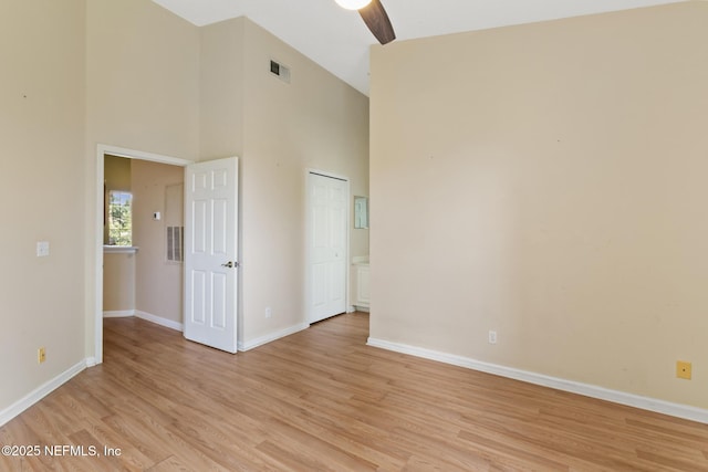 709 Augusta Cir, Saint Augustine, FL 32086 - empty room with light wood-style flooring, baseboards, a towering ceiling, and ceiling fan