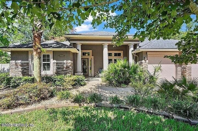 97163 Bluff View Cir, Yulee, FL 32097 - view of front facade with stone siding, a garage, and stucco siding