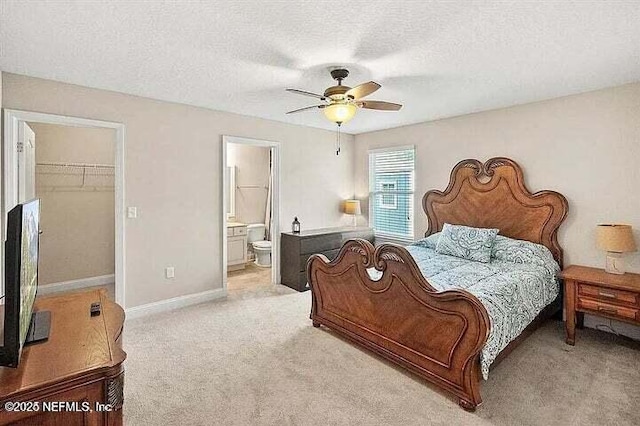 97163 Bluff View Cir, Yulee, FL 32097 - bedroom featuring a walk in closet, light colored carpet, a closet, a textured ceiling, and a ceiling fan