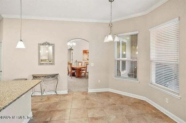 97163 Bluff View Cir, Yulee, FL 32097 - dining area with arched walkways, ornamental molding, light tile patterned floors, and healthy amount of natural light