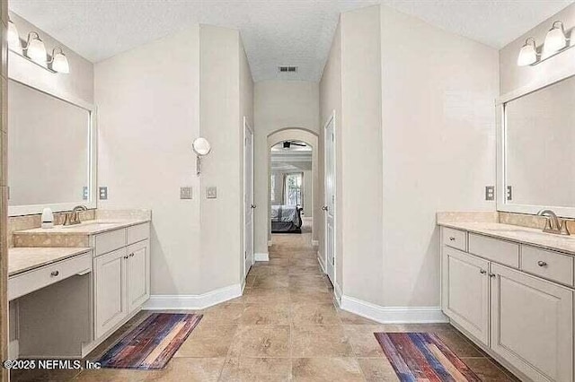 97163 Bluff View Cir, Yulee, FL 32097 - ensuite bathroom featuring two vanities and a textured ceiling